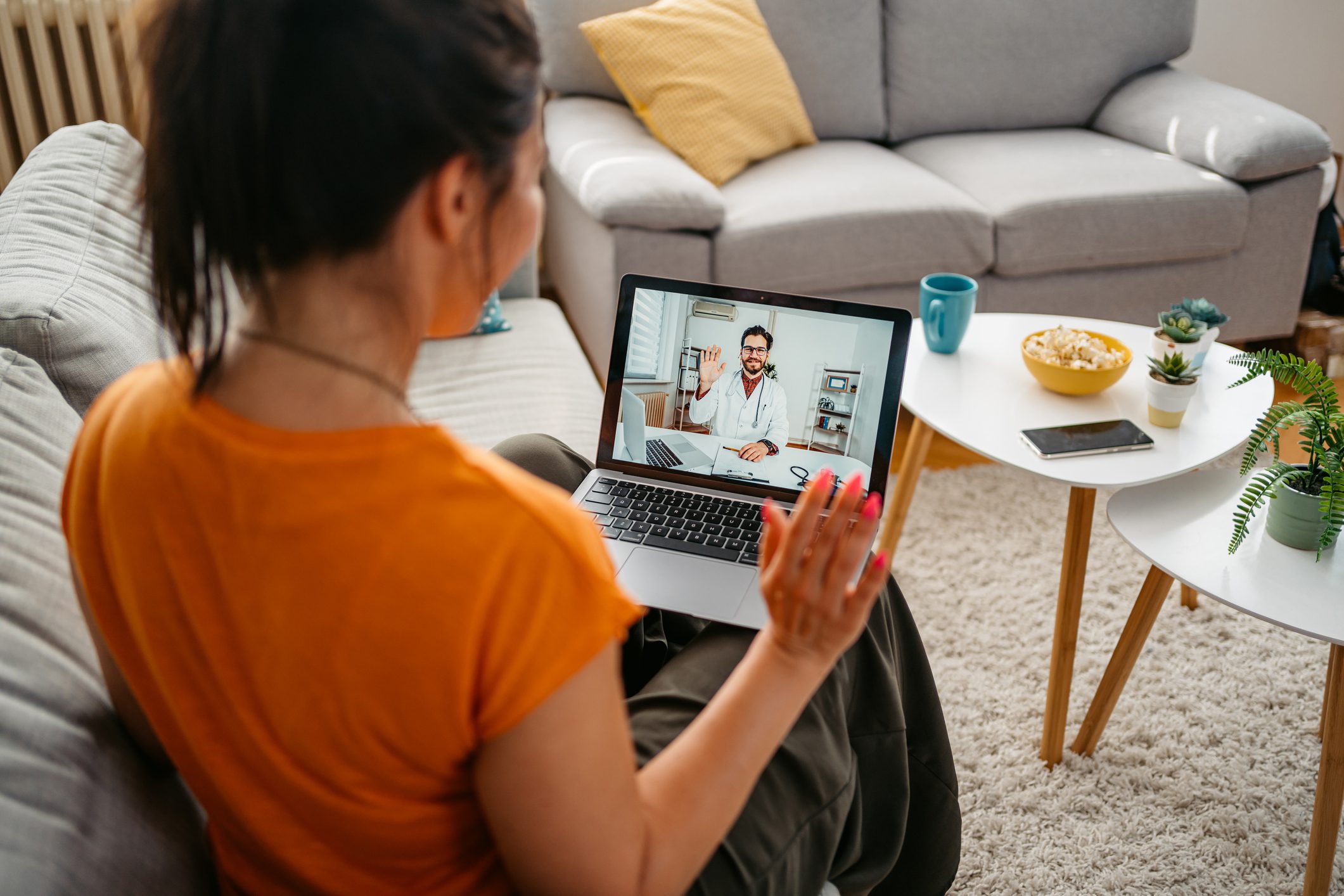 Young Woman Having A Doctor's Appointment Online At Home